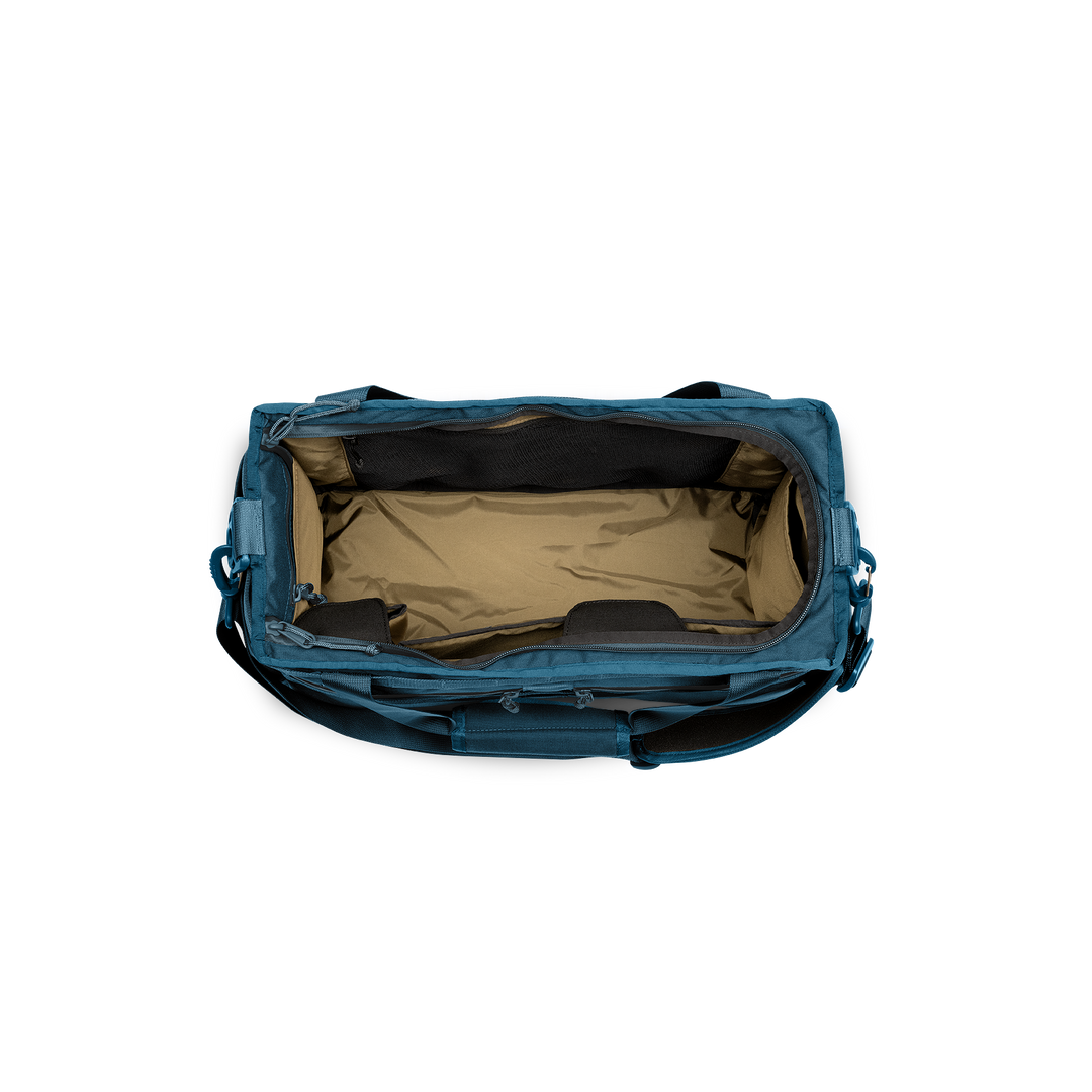 32L Mission Hauler Tote (Wander Blue) with main compartment open showing Coyote interior and pockets on a white background / Wander Blue