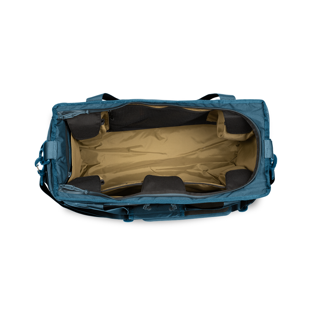 45L Mission Hauler Tote (Wander Blue) with main compartment open showing Coyote interior and pockets on a white background / Wander Blue