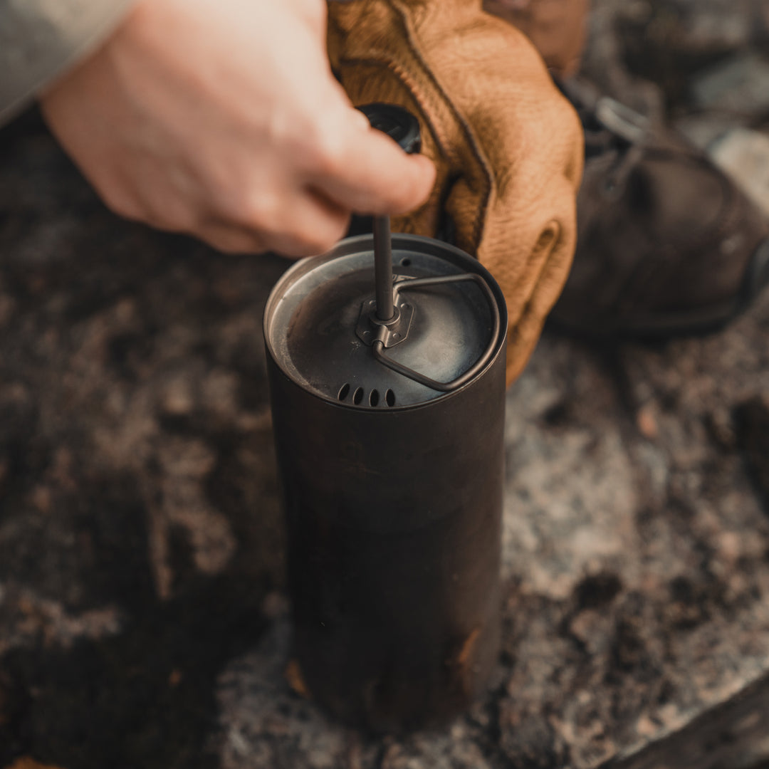 Making coffee with a Grayl® Titanium French Press on natural rock