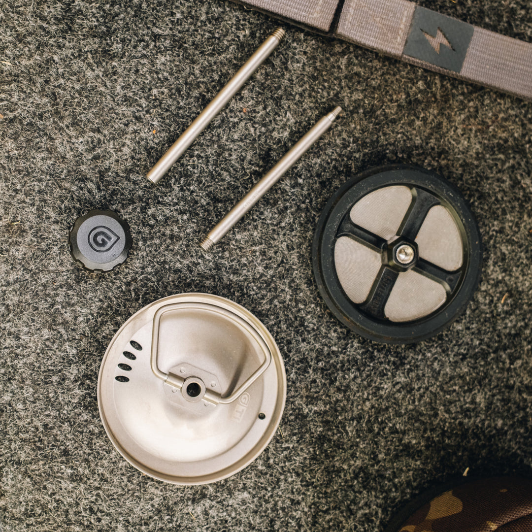 Disassembled parts of the Titanium Coffee Press Accessory Kit (aka French Press) for their Grayl GeoPress Ti